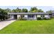 Charming single-story home featuring a well-maintained lawn, covered parking, and attractive landscaping at 4006 Kasper Dr, Orlando, FL 32806