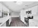 Modern kitchen boasts stainless steel appliances, white cabinetry, and sleek countertops at 4006 Kasper Dr, Orlando, FL 32806