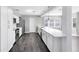 Modern kitchen boasting white cabinets, stainless steel appliances, and laminate flooring at 4006 Kasper Dr, Orlando, FL 32806