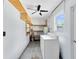 Functional laundry room equipped with washer, dryer, and shelving at 4006 Kasper Dr, Orlando, FL 32806