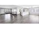Bright, open-plan living area featuring gray laminate floors and an open flow to the kitchen at 4006 Kasper Dr, Orlando, FL 32806