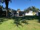 Backyard featuring a well-maintained lawn, a covered patio, and a serene outdoor space at 421 Ohio Ave, St Cloud, FL 34769