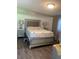 Bedroom featuring a gray bed frame, neutral walls, and wood flooring at 421 Ohio Ave, St Cloud, FL 34769