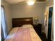 Bedroom featuring a bed, nightstand, and dark wood flooring at 421 Ohio Ave, St Cloud, FL 34769