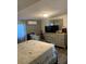 Bedroom featuring a dresser, mounted TV, and neutral colored walls at 421 Ohio Ave, St Cloud, FL 34769
