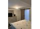 Bedroom featuring a large dresser, mirror, sliding barn door, and neutral colored walls at 421 Ohio Ave, St Cloud, FL 34769