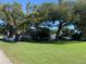 Quaint home shaded by mature trees, with a spacious lawn and an exterior view at 421 Ohio Ave, St Cloud, FL 34769