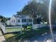 Inviting white home featuring a picket fence and lush green lawn at 421 Ohio Ave, St Cloud, FL 34769