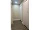 Hallway featuring gray wood flooring and white doors at 421 Ohio Ave, St Cloud, FL 34769