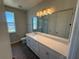 Bathroom featuring double vanity with large mirror and separate shower at 441 Lady Palm St, Apopka, FL 32703