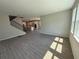 Bright and airy living room featuring wood-look tile flooring, staircase, and ample natural light at 441 Lady Palm St, Apopka, FL 32703