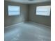 Bedroom featuring tile flooring, neutral colors, and two windows at 4732 Luce Rd, Lakeland, FL 33813