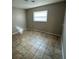 Bedroom with tile floors, neutral paint, and natural light at 4732 Luce Rd, Lakeland, FL 33813