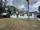 Exterior view of a single-story home with a driveway, lawn, and neutral paint at 4732 Luce Rd, Lakeland, FL 33813