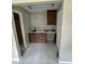 Renovated laundry room with tiled flooring and wooden cabinets at 4732 Luce Rd, Lakeland, FL 33813