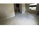 A spacious living room with tile flooring adjacent to the kitchen area and natural lighting at 4732 Luce Rd, Lakeland, FL 33813