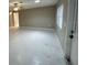 Living room with fan, tile floor, and windows overlooking the yard at 4732 Luce Rd, Lakeland, FL 33813