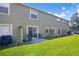 Green backyard features a patio, lush lawn, and privacy dividers for outdoor enjoyment at 509 Cresting Oak Cir # 73, Orlando, FL 32824