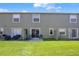Green backyard features a patio, lush lawn, and privacy dividers for outdoor enjoyment at 509 Cresting Oak Cir # 73, Orlando, FL 32824