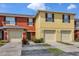 Inviting townhome featuring colorful exteriors, attached garages, and well maintained landscaping at 509 Cresting Oak Cir # 73, Orlando, FL 32824