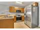 Functional kitchen features stainless steel appliances, ample counter space, and ceramic tile flooring at 509 Cresting Oak Cir # 73, Orlando, FL 32824