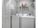 Functional laundry room featuring a washer, dryer, and shelving for efficient organization at 509 Cresting Oak Cir # 73, Orlando, FL 32824