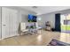 Bright living room with neutral walls, tile floors, and sliding glass doors leading to outdoor green space at 509 Cresting Oak Cir # 73, Orlando, FL 32824