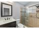 Modern bathroom with updated vanity, toilet, and tiled shower with glass door at 5703 Arnold Zlotoff Dr, Orlando, FL 32821