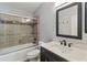 Updated bathroom featuring a modern vanity, toilet, and a tub/shower with tiled surround at 5703 Arnold Zlotoff Dr, Orlando, FL 32821