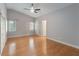 Serene bedroom with hardwood floors, neutral paint, and ample natural light from the large windows at 5703 Arnold Zlotoff Dr, Orlando, FL 32821