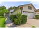 Inviting home exterior features a well-maintained lawn and lovely landscaping around the entrance at 5703 Arnold Zlotoff Dr, Orlando, FL 32821