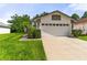 Charming home with a well-manicured lawn and a two-car garage, perfect for suburban living at 5703 Arnold Zlotoff Dr, Orlando, FL 32821