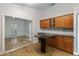 Well-appointed kitchen with granite countertops, wood cabinets, and convenient breakfast bar seating area at 5703 Arnold Zlotoff Dr, Orlando, FL 32821