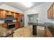 Modern kitchen with stainless steel appliances, granite countertops, and stylish wooden cabinetry at 5703 Arnold Zlotoff Dr, Orlando, FL 32821