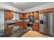 Updated kitchen featuring stainless steel appliances, granite countertops, and stylish tile backsplash at 5703 Arnold Zlotoff Dr, Orlando, FL 32821