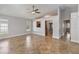 Open-concept living room with tile floors, neutral walls, and a seamless transition to the kitchen at 5703 Arnold Zlotoff Dr, Orlando, FL 32821