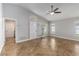 Bright living room boasts high ceilings, tile flooring, and ample natural light from multiple windows at 5703 Arnold Zlotoff Dr, Orlando, FL 32821