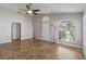 Spacious living room with tile floors, large windows, and a bright atmosphere for comfortable living at 5703 Arnold Zlotoff Dr, Orlando, FL 32821