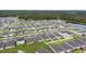 Aerial view of neighborhood with well-maintained lawns, trees and nearby body of water at 5808 Arboretum St, St Cloud, FL 34771