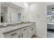 Bathroom with double granite countertop vanity, undermount sinks, and bright natural light at 5808 Arboretum St, St Cloud, FL 34771