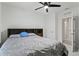 Bedroom with gray bedding and a ceiling fan at 5808 Arboretum St, St Cloud, FL 34771