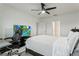 Relaxing bedroom featuring white walls, sleek black fan, and comfortable furniture at 5808 Arboretum St, St Cloud, FL 34771