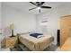 Bedroom with beige bedding, a ceiling fan, and a window with blinds at 5808 Arboretum St, St Cloud, FL 34771