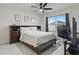 Comfortable bedroom featuring sleek white walls, dark furniture, and bright windows at 5808 Arboretum St, St Cloud, FL 34771