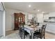Dining area with dark wood table and chairs, and a hutch in an open concept kitchen/dining area at 5808 Arboretum St, St Cloud, FL 34771