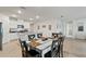 Dining area with dark wood table and chairs, with an open concept kitchen in the background at 5808 Arboretum St, St Cloud, FL 34771