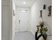Bright entryway with neutral paint, ceramic tile flooring, and decorative table with fresh flowers at 5808 Arboretum St, St Cloud, FL 34771