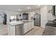 Kitchen with white cabinets, stainless appliances, granite counters, and center island with sink and dishwasher at 5808 Arboretum St, St Cloud, FL 34771