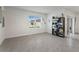 Bright living room featuring tile floors, a window with natural light, and a bookshelf at 5808 Arboretum St, St Cloud, FL 34771