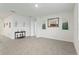 Open living room with tile floors, neutral paint, and minimalist decor at 5808 Arboretum St, St Cloud, FL 34771